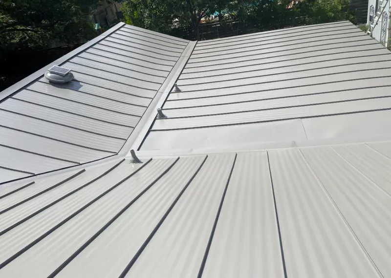 Solar attic fan installed on a metal roof for Roof Ventilation in Greenbelt